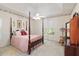 A spacious main bedroom with a four-poster bed, ceiling fan and neutral walls at 219 Garden W Walk, Hampton, GA 30228