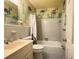 Bathroom showcasing a single sink vanity, toilet, shower with tub, and decorative wallpaper for a cohesive look at 2603 Kings Lake Ne Ct, Atlanta, GA 30345