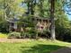Charming two-story brick home with lush landscaping and a classic red front door at 2603 Kings Lake Ne Ct, Atlanta, GA 30345