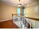 The Hallway features hardwood floors, white trim, and a staircase with wood handrails for a classic and elegant look at 2603 Kings Lake Ne Ct, Atlanta, GA 30345