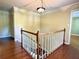 Hallway with hardwood floors and wooden banister at 2603 Kings Lake Ne Ct, Atlanta, GA 30345