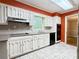 Functional kitchen with white cabinetry, black appliances, and light-colored countertops at 2603 Kings Lake Ne Ct, Atlanta, GA 30345