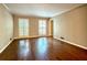 Bright and airy living room with gleaming hardwood floors and large windows at 2603 Kings Lake Ne Ct, Atlanta, GA 30345