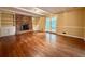 Cozy living room featuring a brick fireplace, built-in shelving, and hardwood floors at 2603 Kings Lake Ne Ct, Atlanta, GA 30345