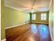 Living room with hardwood floors, ceiling fan, and two windows at 2603 Kings Lake Ne Ct, Atlanta, GA 30345