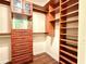 Spacious walk-in closet featuring custom wood shelving and ample storage space for clothes, shoes, and accessories at 2603 Kings Lake Ne Ct, Atlanta, GA 30345
