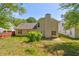 The home features a grassy backyard with privacy fence and mature trees at 6396 Phillips Ct, Lithonia, GA 30058