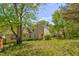 Large backyard with mature trees and lush green grass, providing a private and serene outdoor setting at 6396 Phillips Ct, Lithonia, GA 30058