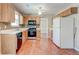 Kitchen with tile backsplash, wood cabinets, and modern appliances at 6396 Phillips Ct, Lithonia, GA 30058
