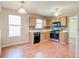 Kitchen featuring wood cabinets and stainless steel oven range with an adjacent dining space at 6396 Phillips Ct, Lithonia, GA 30058