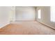 Spacious living room with neutral carpet, light walls, and large windows at 6396 Phillips Ct, Lithonia, GA 30058