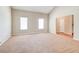 Large living room with neutral carpet, light walls, and views into the foyer at 6396 Phillips Ct, Lithonia, GA 30058