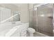Bright bathroom featuring a white vanity, toilet, and tiled shower with glass doors at 809 Kirby Dr, Woodstock, GA 30188