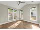 Bright bedroom with wood floors, a ceiling fan, and multiple windows offering natural light at 809 Kirby Dr, Woodstock, GA 30188