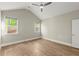 A well-lit bedroom featuring vaulted ceilings, hardwood floors, recessed lights, and a ceiling fan at 809 Kirby Dr, Woodstock, GA 30188