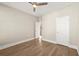 Hardwood floored bedroom featuring a ceiling fan and standard closet door at 809 Kirby Dr, Woodstock, GA 30188