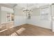 Bright dining room featuring modern light fixture, wainscoting and hardwood floors at 809 Kirby Dr, Woodstock, GA 30188