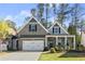 Charming brick home featuring a two-car garage and a welcoming front porch at 809 Kirby Dr, Woodstock, GA 30188