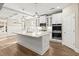 Bright kitchen with stainless appliances, granite island, and hardwood floors at 809 Kirby Dr, Woodstock, GA 30188