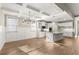 Open kitchen and dining area with hardwood floors, coffered ceilings, an island, and stainless appliances at 809 Kirby Dr, Woodstock, GA 30188