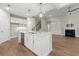 Open kitchen with granite island, stainless appliances, hardwood floors, and fireplace at 809 Kirby Dr, Woodstock, GA 30188