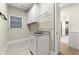 Well-lit laundry room features granite countertop, sink, hanging rack, and ample storage at 809 Kirby Dr, Woodstock, GA 30188