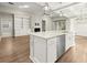 Open concept living room with kitchen island, fireplace, and lots of natural light at 809 Kirby Dr, Woodstock, GA 30188