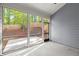 Screened-in porch with a view of the wooded backyard and fence at 809 Kirby Dr, Woodstock, GA 30188