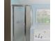 Fresh bathroom featuring a jetted tub, frosted glass shower doors, and a window at 850 Madison Chase Way, Lawrenceville, GA 30045