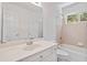 Cozy bathroom featuring a single sink vanity, a window, and a tub and shower combo at 850 Madison Chase Way, Lawrenceville, GA 30045