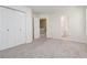 Well-lit bedroom featuring plush carpeting, light walls, and closet with bi-fold doors at 850 Madison Chase Way, Lawrenceville, GA 30045