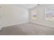 Bright bedroom featuring neutral carpet, base trim, and sunlit windows at 850 Madison Chase Way, Lawrenceville, GA 30045