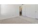 Comfortable bedroom with plush neutral carpet and doorways to closet space and hallway at 850 Madison Chase Way, Lawrenceville, GA 30045