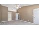 Neutral bedroom with high ceilings, a lighted ceiling fan, and doorway to an ensuite bathroom at 850 Madison Chase Way, Lawrenceville, GA 30045