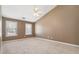 Spacious bedroom featuring neutral carpeting, light-filled windows, and a ceiling fan at 850 Madison Chase Way, Lawrenceville, GA 30045