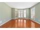Bright bonus room featuring hardwood floors, light green walls, and multiple windows at 850 Madison Chase Way, Lawrenceville, GA 30045