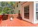 A bright red wood deck provides outdoor living space attached to a white home at 850 Madison Chase Way, Lawrenceville, GA 30045