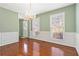 Dining room boasts hardwood floors, chandelier, and light green walls with white trim at 850 Madison Chase Way, Lawrenceville, GA 30045