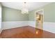 Elegant dining room with hardwood floors, chandelier, and an open view to the kitchen at 850 Madison Chase Way, Lawrenceville, GA 30045