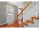 Welcoming entryway featuring hardwood floors, staircase with wooden handrail, and light green walls at 850 Madison Chase Way, Lawrenceville, GA 30045