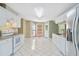 Open kitchen with tile floors, white appliances, and a breakfast nook area at 850 Madison Chase Way, Lawrenceville, GA 30045