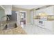 Traditional kitchen featuring granite countertops, white appliances, and tile floors at 850 Madison Chase Way, Lawrenceville, GA 30045