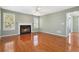 Bright living room features a fireplace, hardwood floors, and a ceiling fan at 850 Madison Chase Way, Lawrenceville, GA 30045
