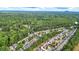 Aerial view of a neighborhood surrounded by lush trees, with many homes at 117 Manous Dr, Canton, GA 30115