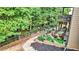 Multi-level backyard featuring a patio, landscaping, a fire pit, and mature trees at 117 Manous Dr, Canton, GA 30115