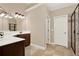 Bathroom featuring double sinks, granite counters, tile flooring, and a glass enclosed shower at 117 Manous Dr, Canton, GA 30115