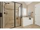 Relaxing bathroom featuring a walk-in shower, soaking tub, neutral tile, and elegant fixtures at 117 Manous Dr, Canton, GA 30115