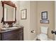 Elegant powder room with a unique vanity, decorative mirror, and stylish fixtures at 117 Manous Dr, Canton, GA 30115