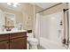 Bathroom with double vanity, toilet, and shower with patterned tile, and a mirror in the background at 117 Manous Dr, Canton, GA 30115