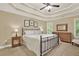 Bedroom with tray ceiling, ceiling fan, shutters and dresser and nightstand, with carpet and neutral walls at 117 Manous Dr, Canton, GA 30115